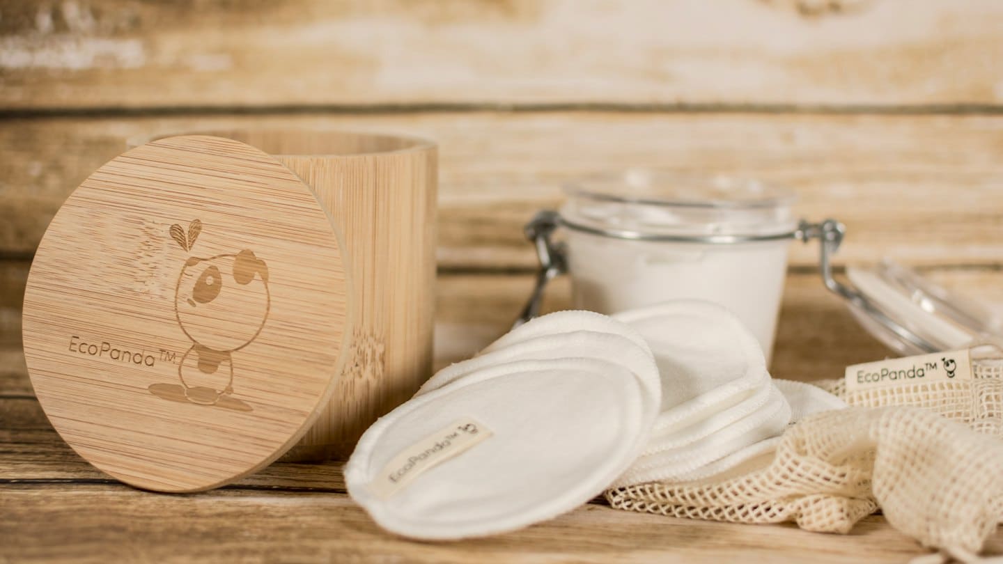 Eco-friendly personal care products arranged on a wooden surface.