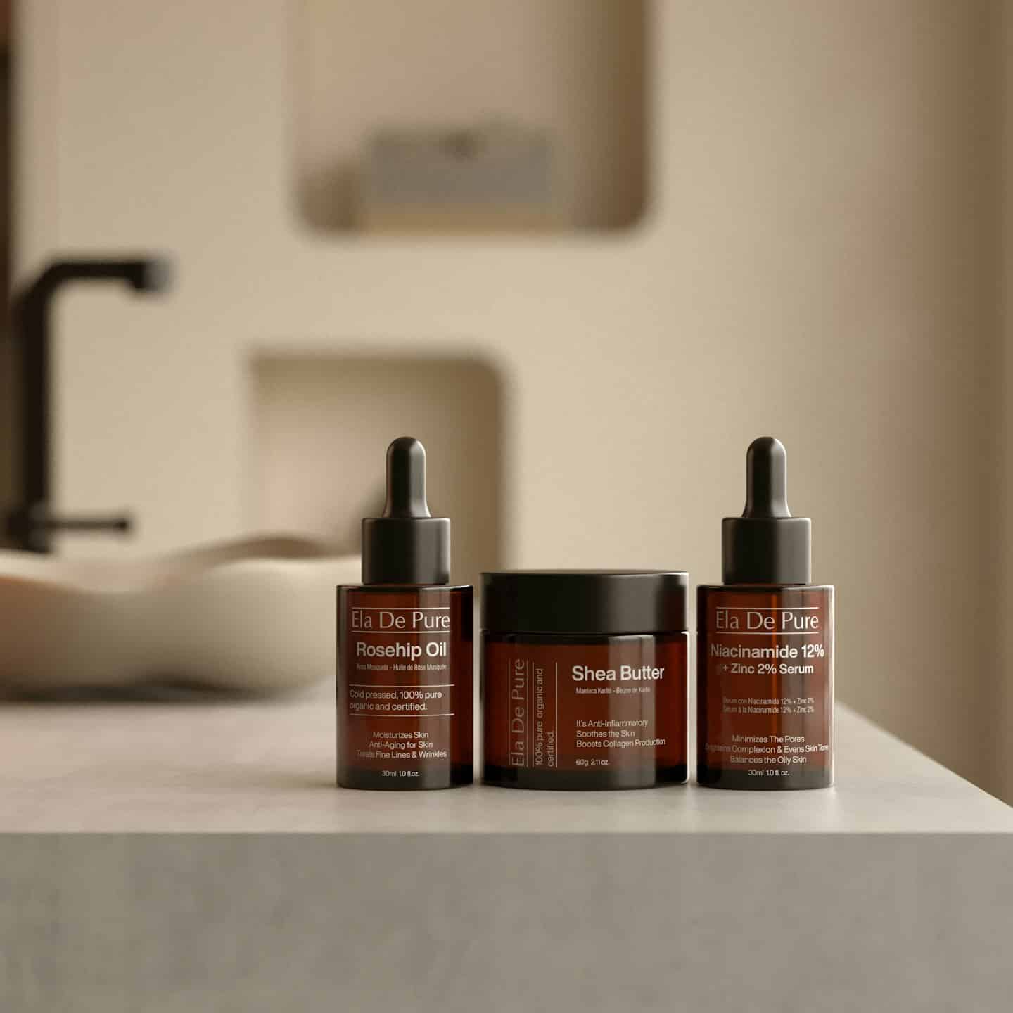 Amber glass skincare bottles and jar on marble counter.